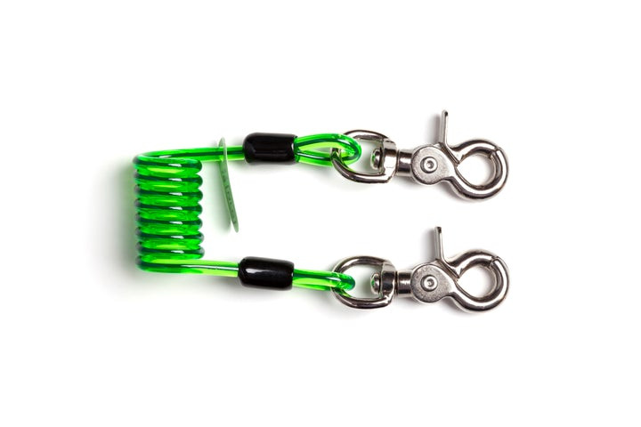 A coiled green plastic tether with two metal swivel snap hooks, one on each end, against a white background.