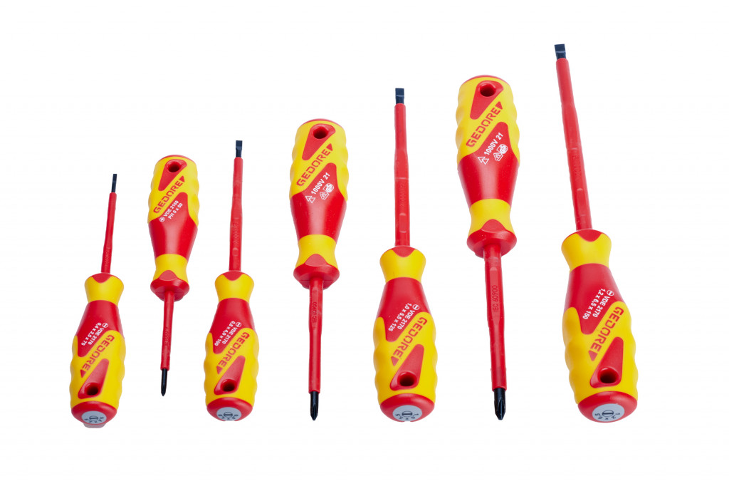 Seven insulated screwdrivers with red shafts and yellow-red handles, arranged in a row from smallest to largest, with various flathead and Phillips tips displayed on a white background.