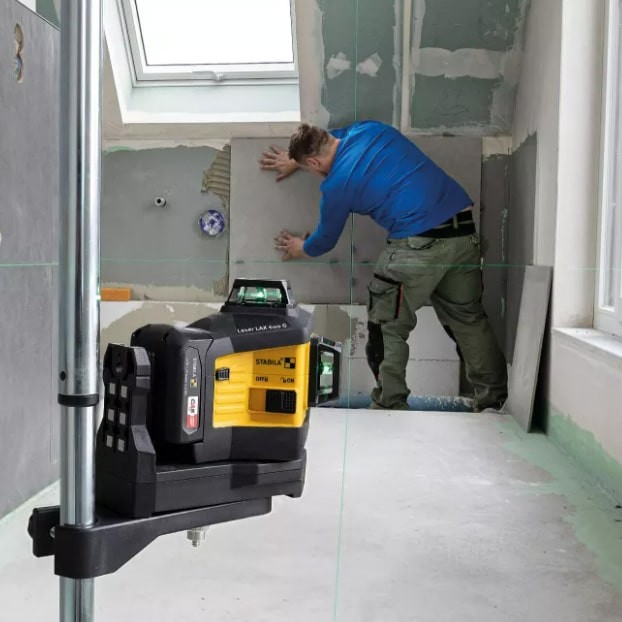 A Stabila self-levelling laser level projecting horizontal and vertical lines, for precision alignment and setting-out work.