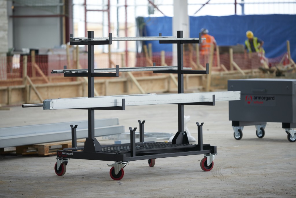 A steel metal shelving unit with adjustable shelf heights and a robust welded steel frame, for organised storage in workshops and site cabins.