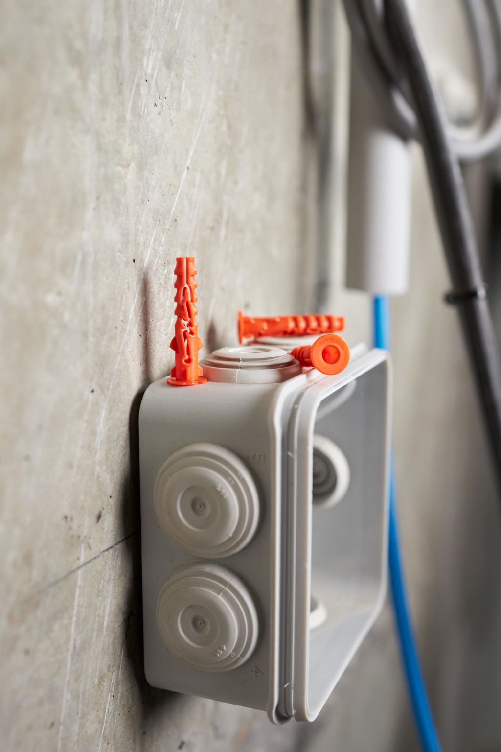 An orange and black Spit cordless power tool, with an ergonomic grip, designed for use on construction and maintenance tasks.