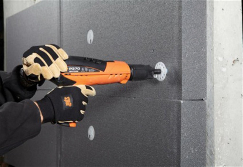 An orange and black Spit cordless power tool, with an ergonomic grip, designed for use on construction and maintenance tasks.