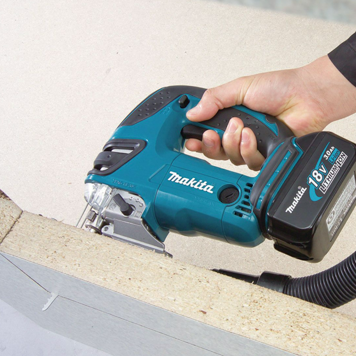 A teal and black Makita cordless jigsaw with 18V orbital action and a variable-speed trigger, for cutting curves and internal shapes.