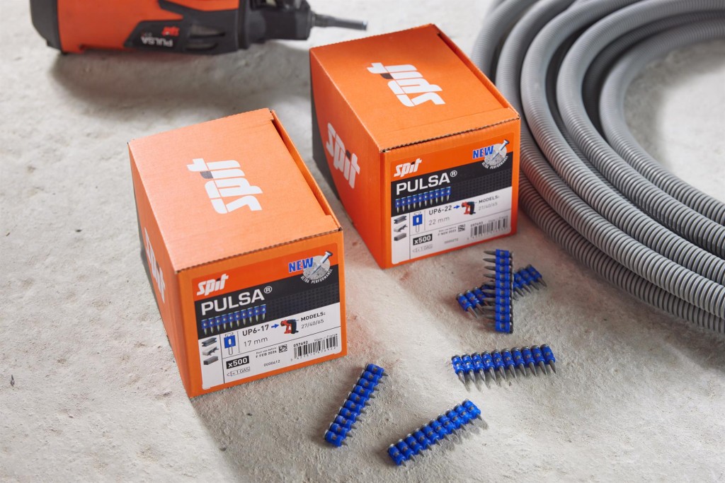 An orange and black Spit cordless power tool, with an ergonomic grip, designed for use on construction and maintenance tasks.