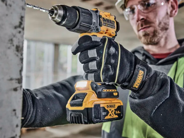 A yellow and black DEWALT cordless combi drill with an 18V motor, a 13mm keyless chuck, and hammer, drill, and screwdriver modes.
