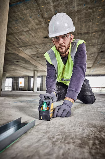 A yellow and black DEWALT self-levelling laser level projecting horizontal and vertical lines, for precision alignment and setting-out work.