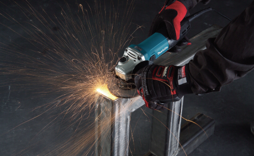 A teal and black Makita corded angle grinder with a 110V motor, a side handle, and a wheel guard, for grinding, cutting, and surface preparation.