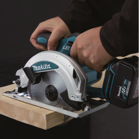 A teal and black Makita cordless circular saw with a 18V motor, an adjustable bevel plate, and a blade guard, for ripping and cross-cutting timber.