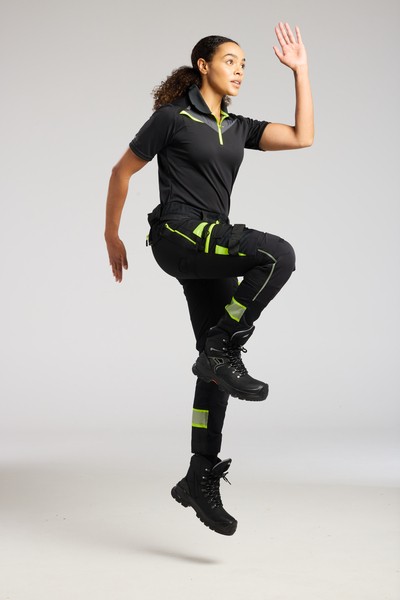 A women's black polo shirt designed for use on construction sites and in industrial work environments.,