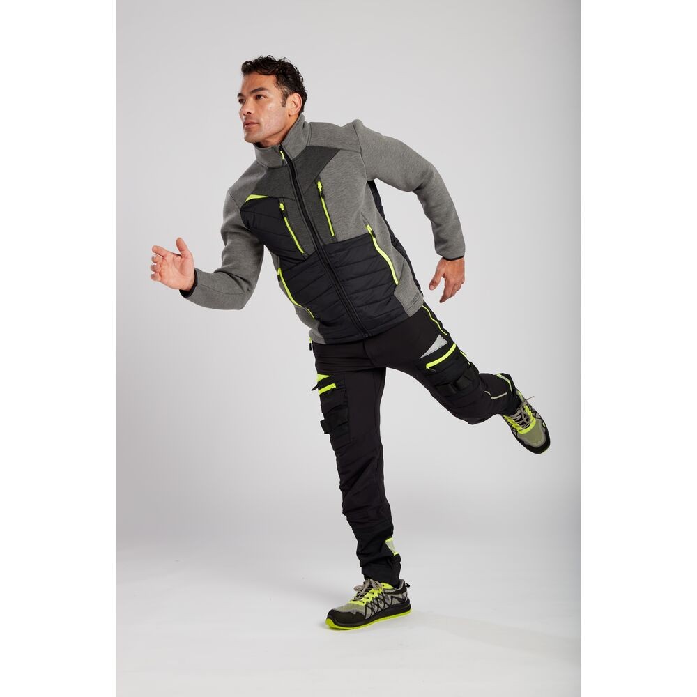 A pair of black work trousers designed for use on construction sites and in industrial work environments.,