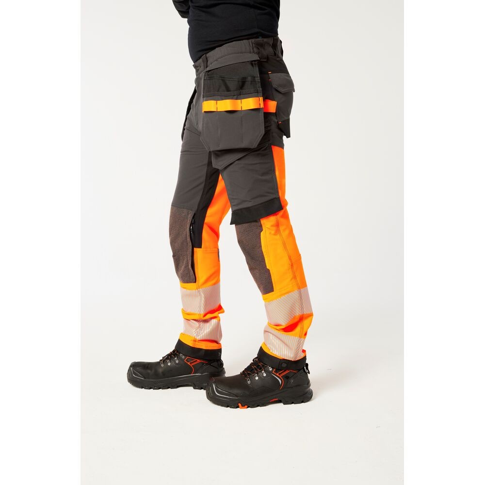 A pair of high-visibility orange trousers featuring retroreflective tape panels, stretch panels for ease of movement, suitable for a wide range of outdoor and site work applications.