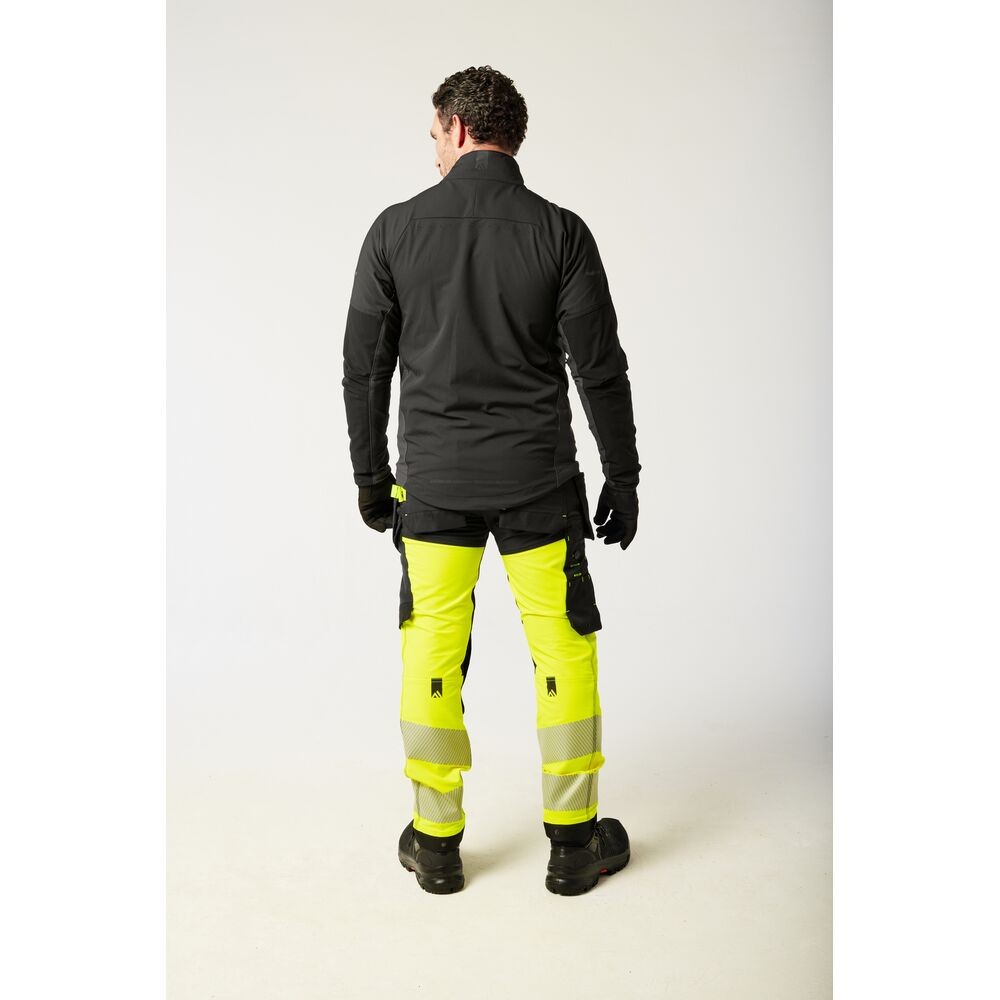 A pair of high-visibility yellow trousers featuring retroreflective tape panels, stretch panels for ease of movement, suitable for a wide range of outdoor and site work applications.