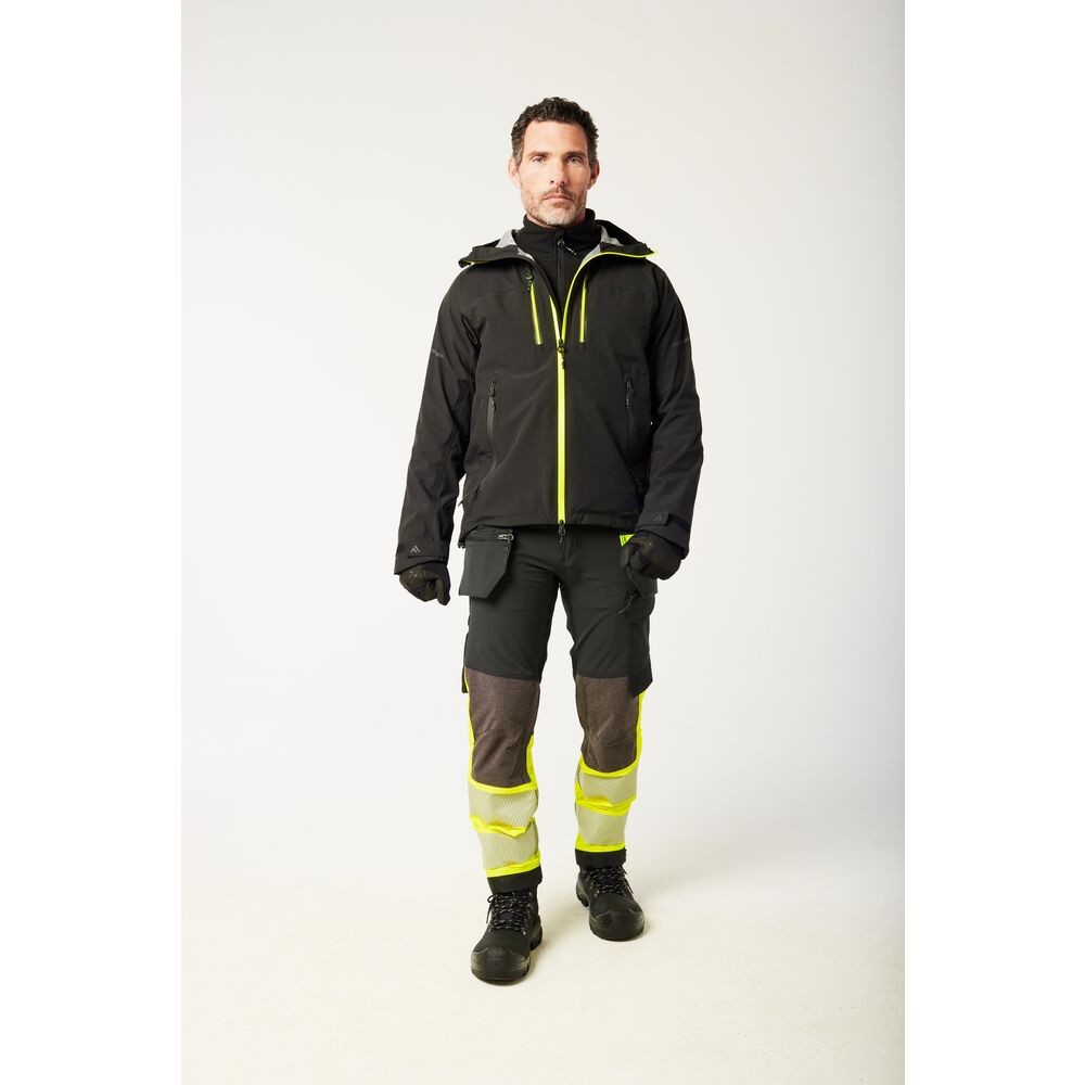A black jacket designed for use on construction sites and in industrial work environments.,