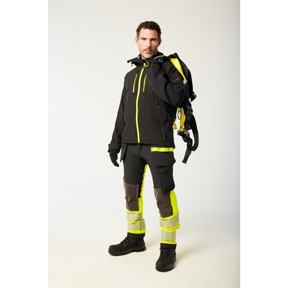 A black jacket designed for use on construction sites and in industrial work environments.,