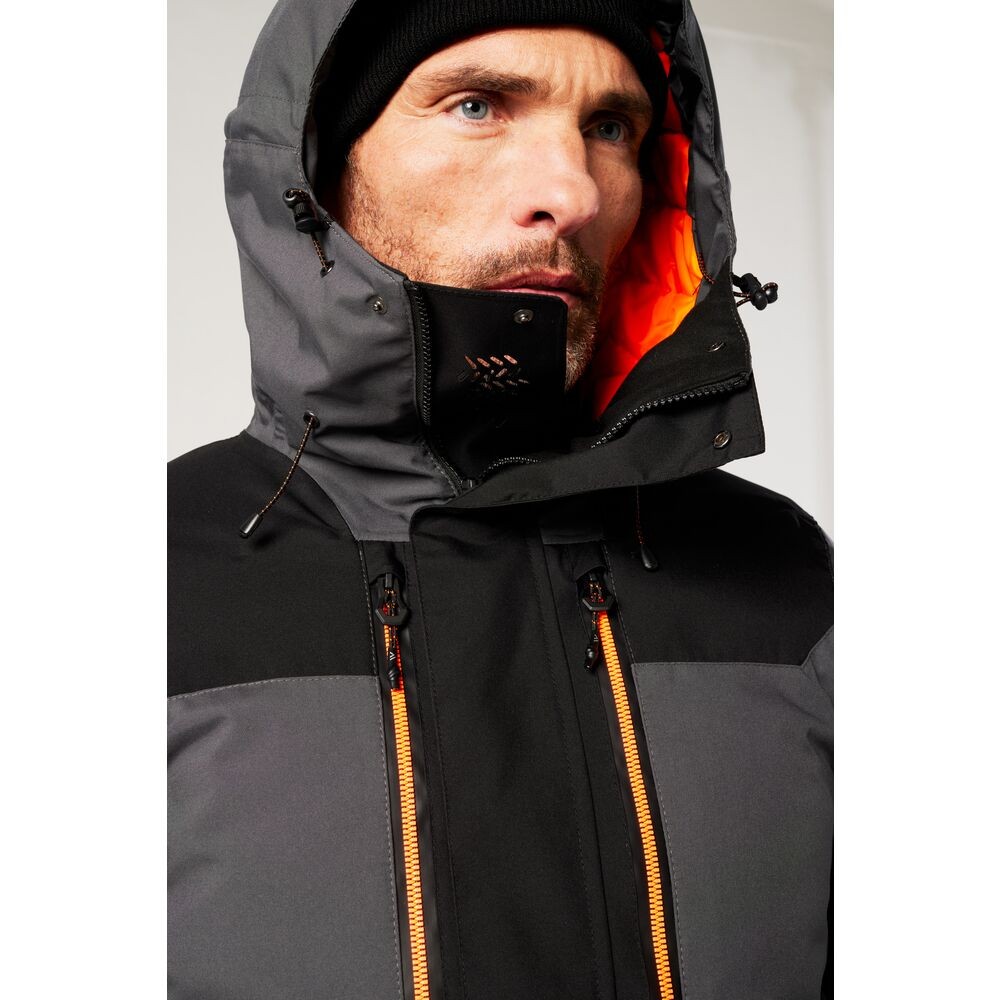 A grey jacket designed for use on construction sites and in industrial work environments.,