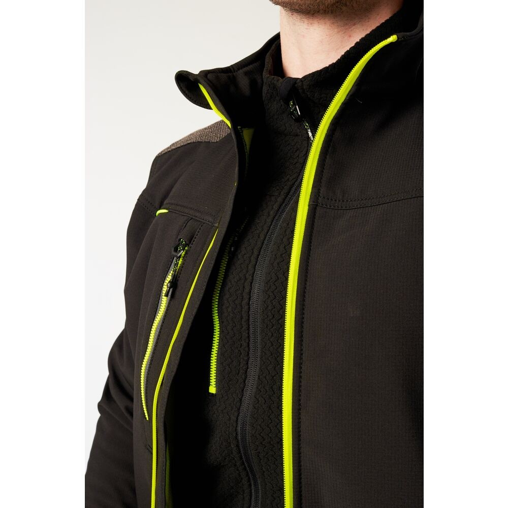 A black softshell jacket designed for use on construction sites and in industrial work environments.,
