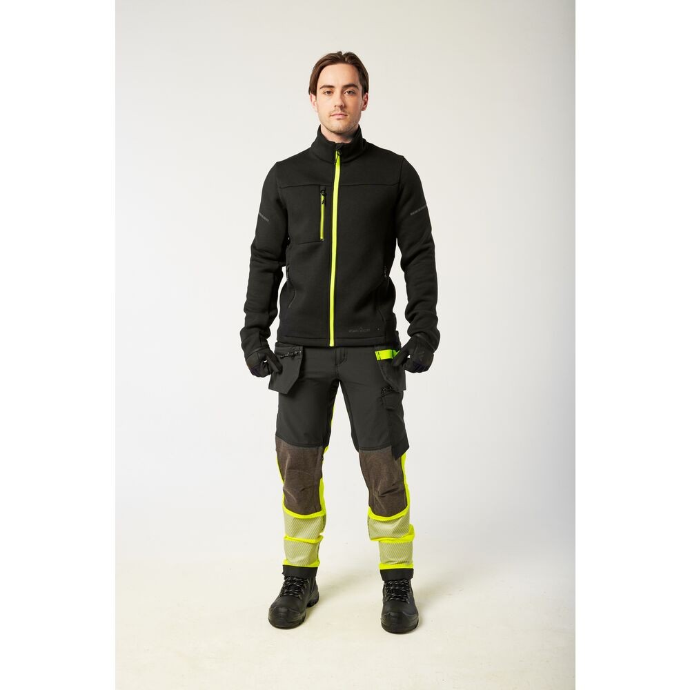 A black softshell jacket designed for use on construction sites and in industrial work environments.,
