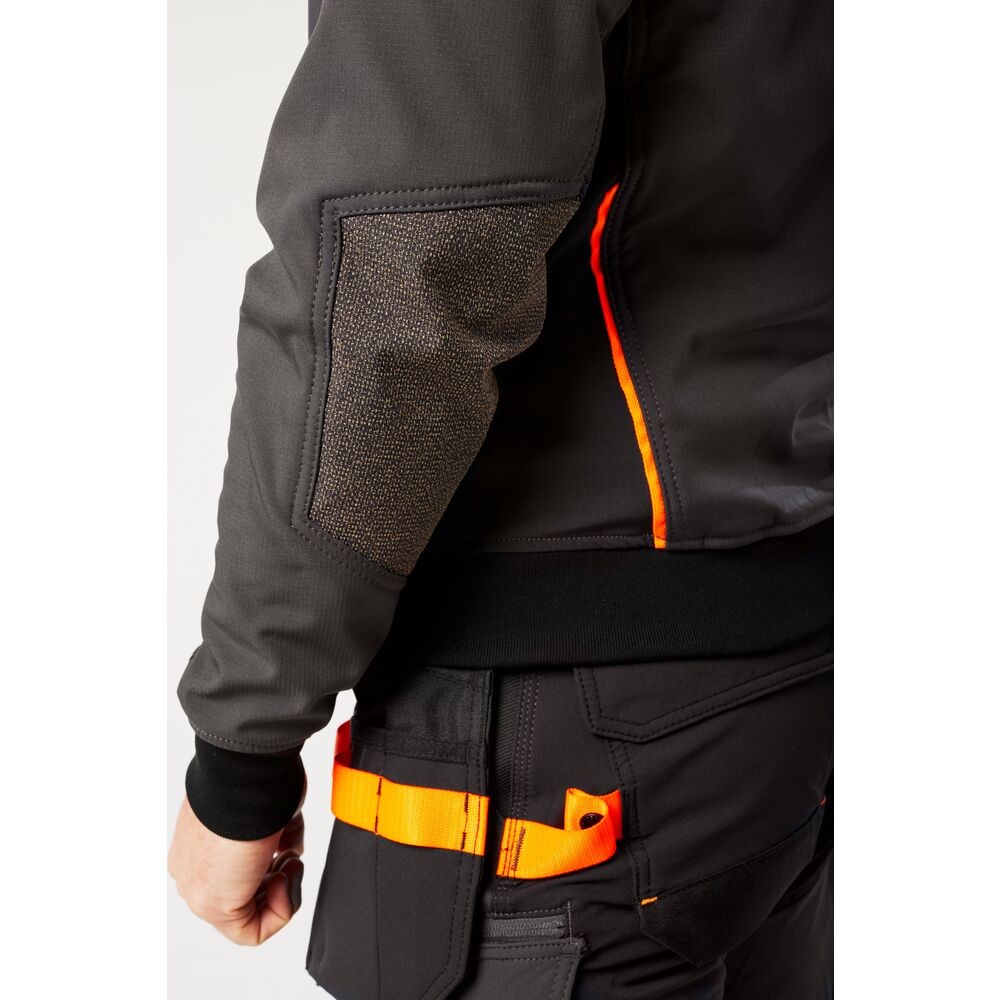 A grey softshell jacket designed for use on construction sites and in industrial work environments.,