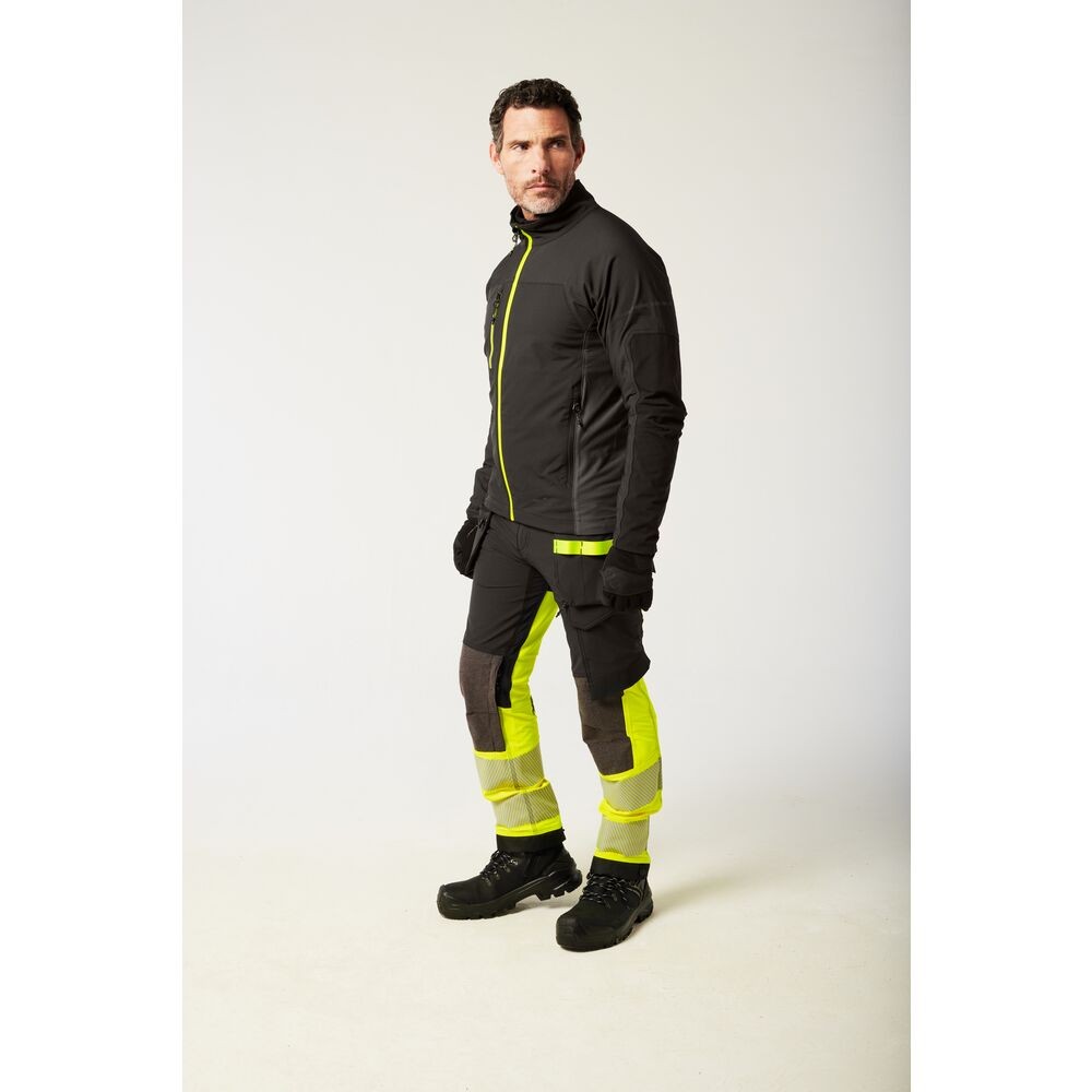 A black jacket featuring stretch panels for ease of movement, suitable for a wide range of outdoor and site work applications.