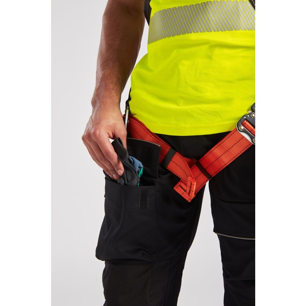 A black workwear garment designed for use on construction sites and in industrial work environments.,