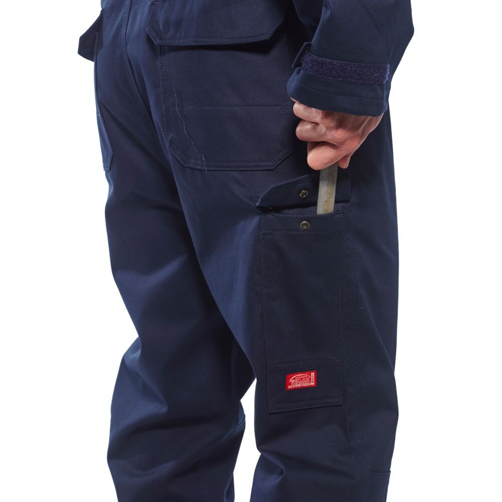 A navy blue coverall featuring flame-resistant fabric, suitable for a wide range of outdoor and site work applications.