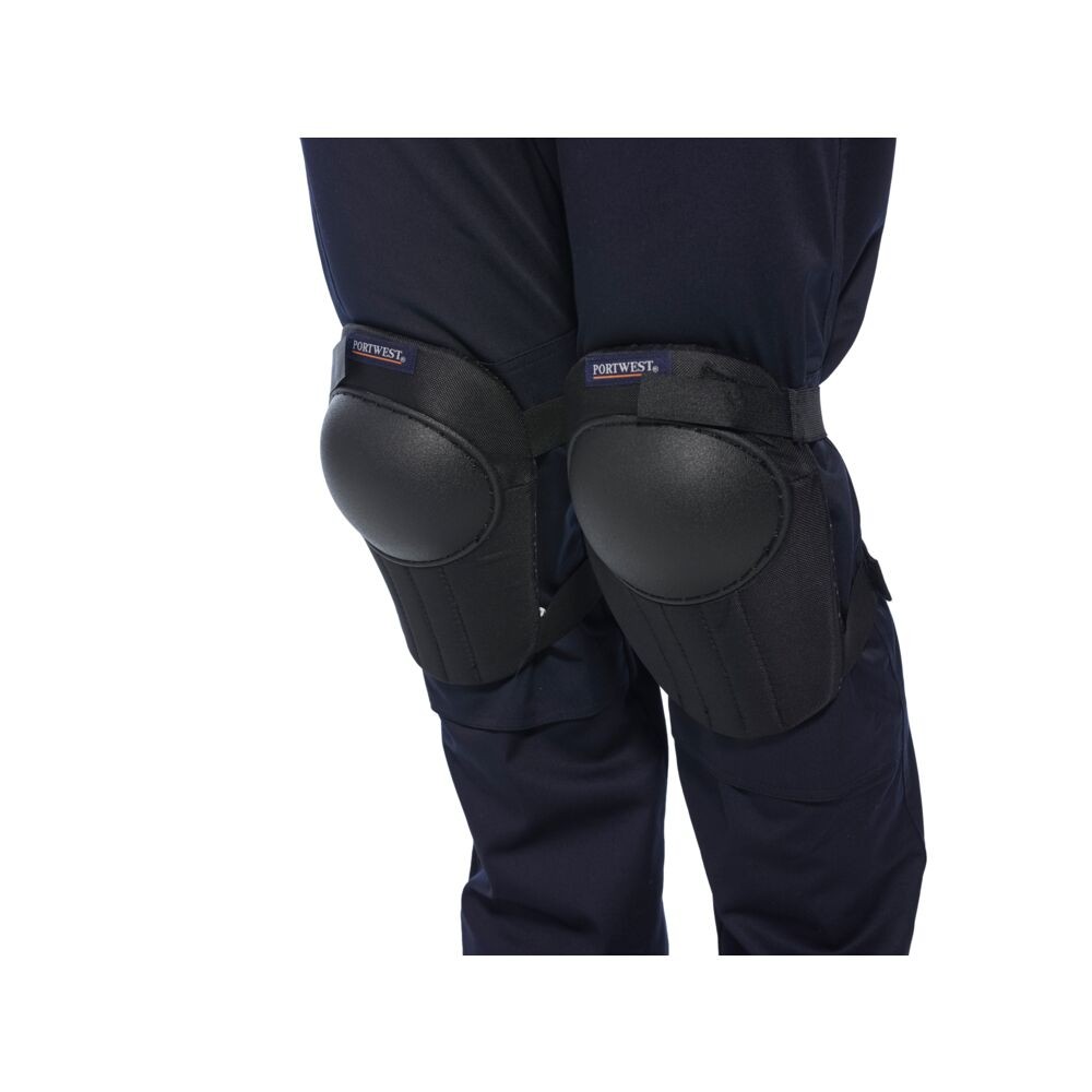 A pair of black foam-padded knee pads with adjustable straps, designed to protect the knees during kneeling work.