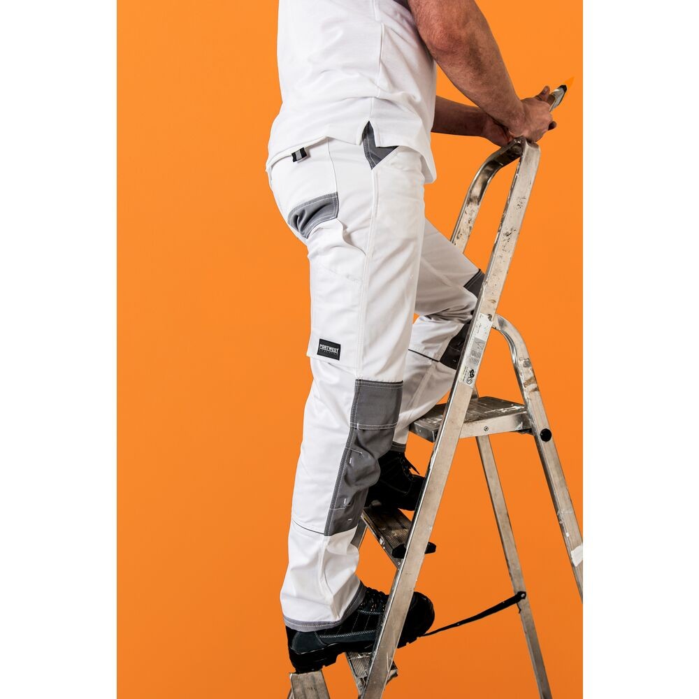 A pair of white work trousers designed for use on construction sites and in industrial work environments.,
