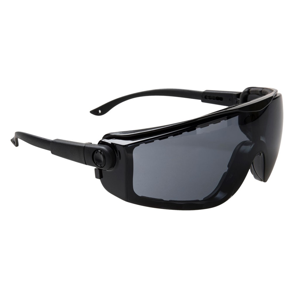 A pair of safety spectacles with clear impact-resistant lenses and adjustable side arms, for eye protection during site work.
