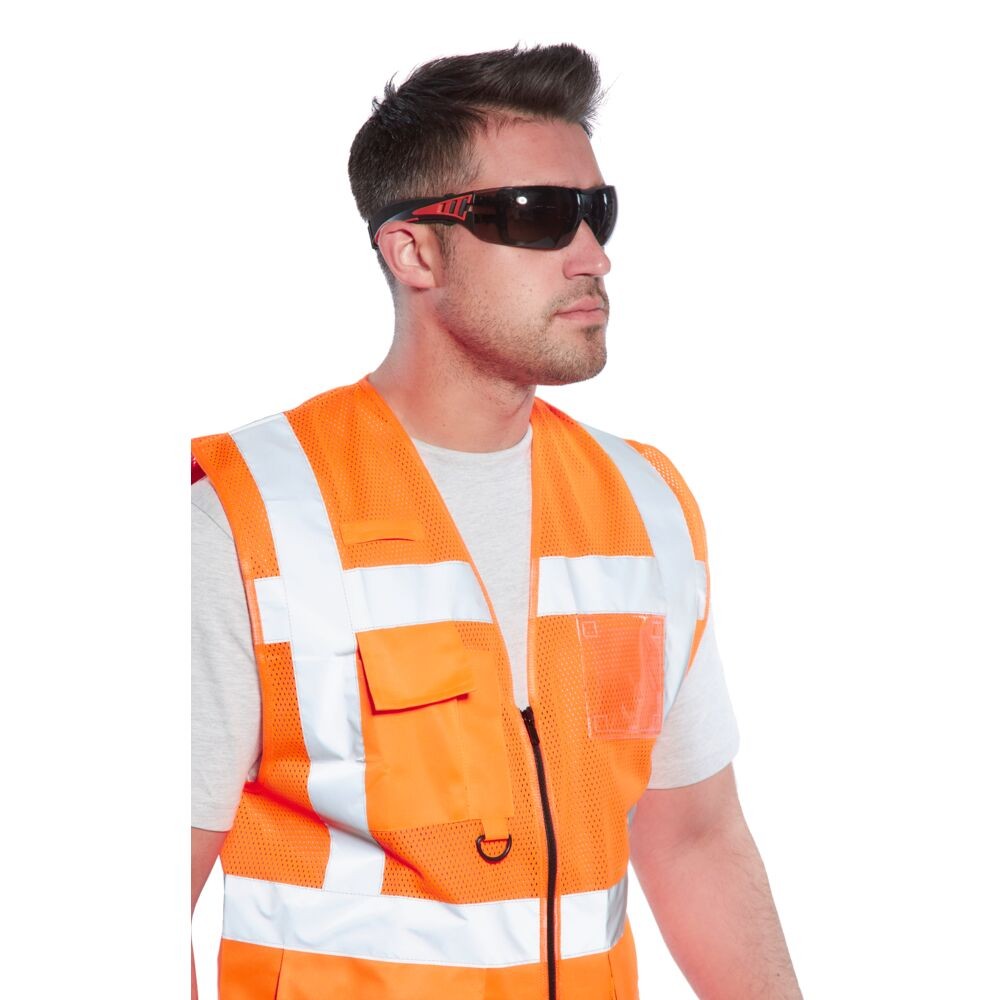 A pair of safety spectacles with clear impact-resistant lenses and adjustable side arms, for eye protection during site work.