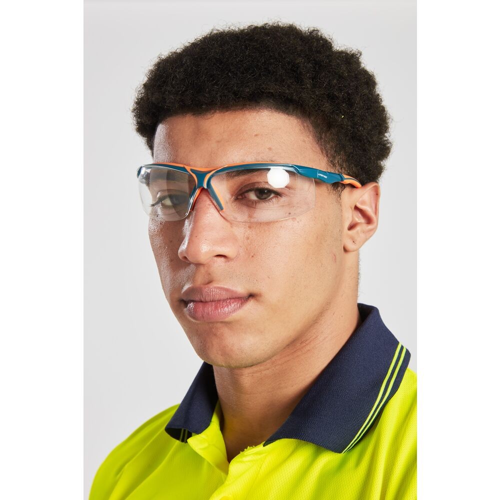 A pair of safety spectacles with clear impact-resistant lenses and adjustable side arms, for eye protection during site work.