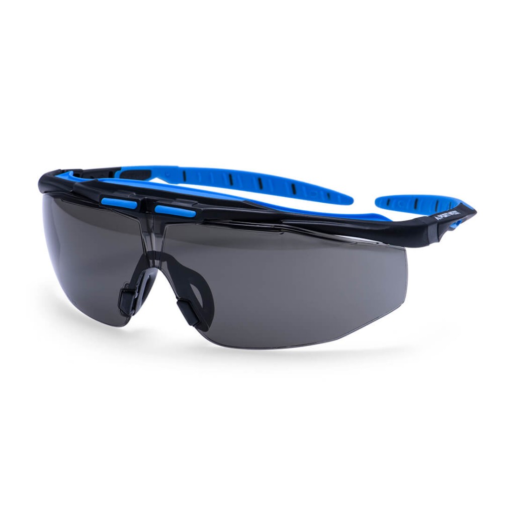 A pair of safety spectacles with clear impact-resistant lenses and adjustable side arms, for eye protection during site work.