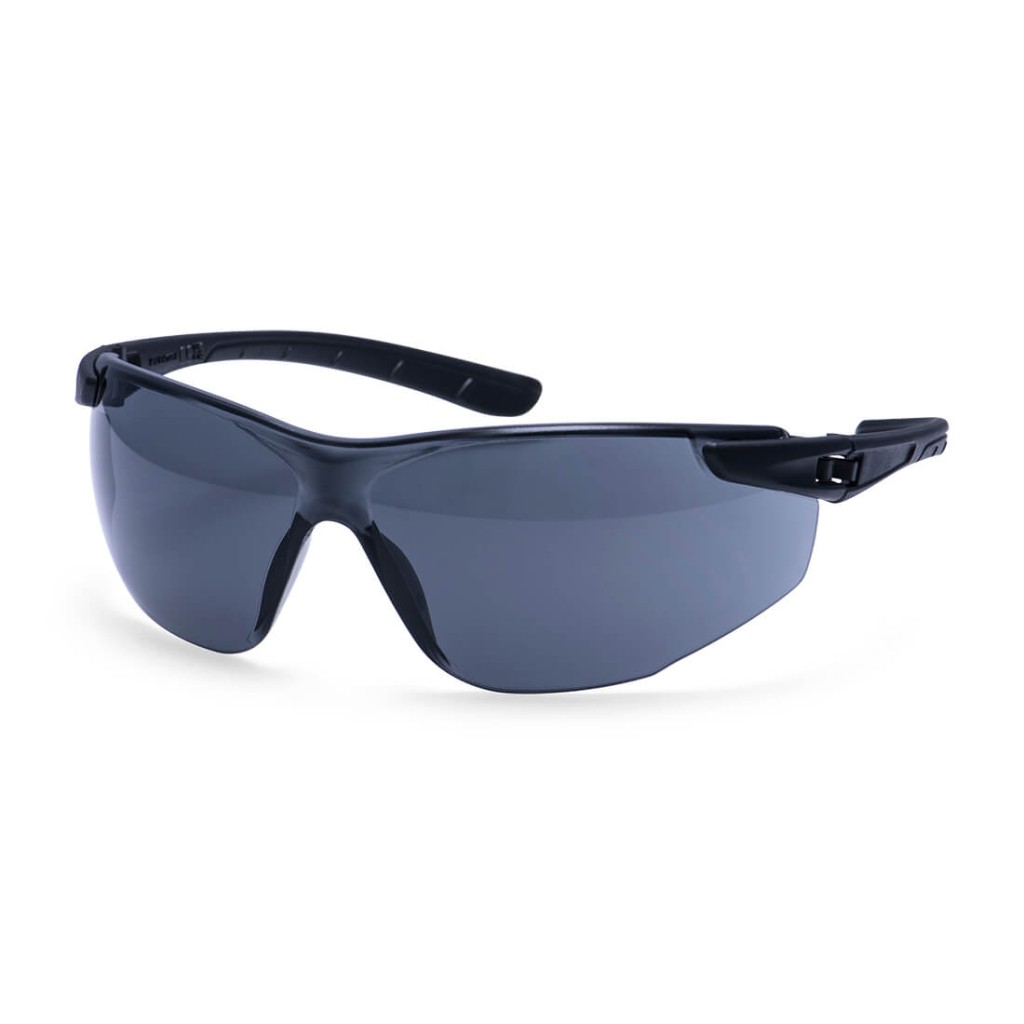 A pair of safety spectacles with clear impact-resistant lenses and adjustable side arms, for eye protection during site work.