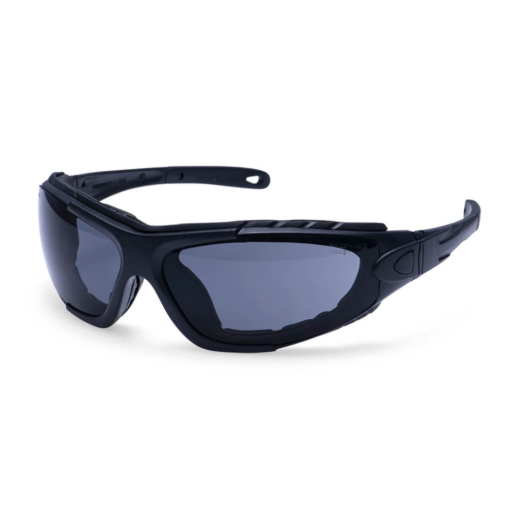 A pair of safety spectacles with clear impact-resistant lenses and adjustable side arms, for eye protection during site work.