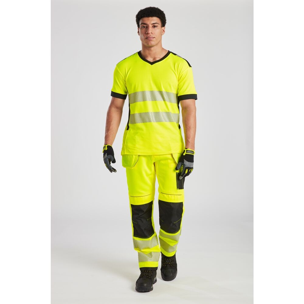 A high-visibility yellow work shirt featuring retroreflective tape panels, suitable for a wide range of outdoor and site work applications.
