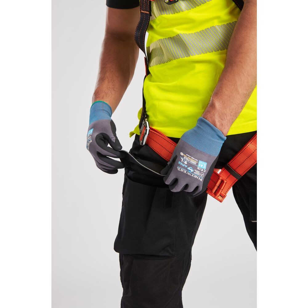 A pair of black work trousers designed for use on construction sites and in industrial work environments.,