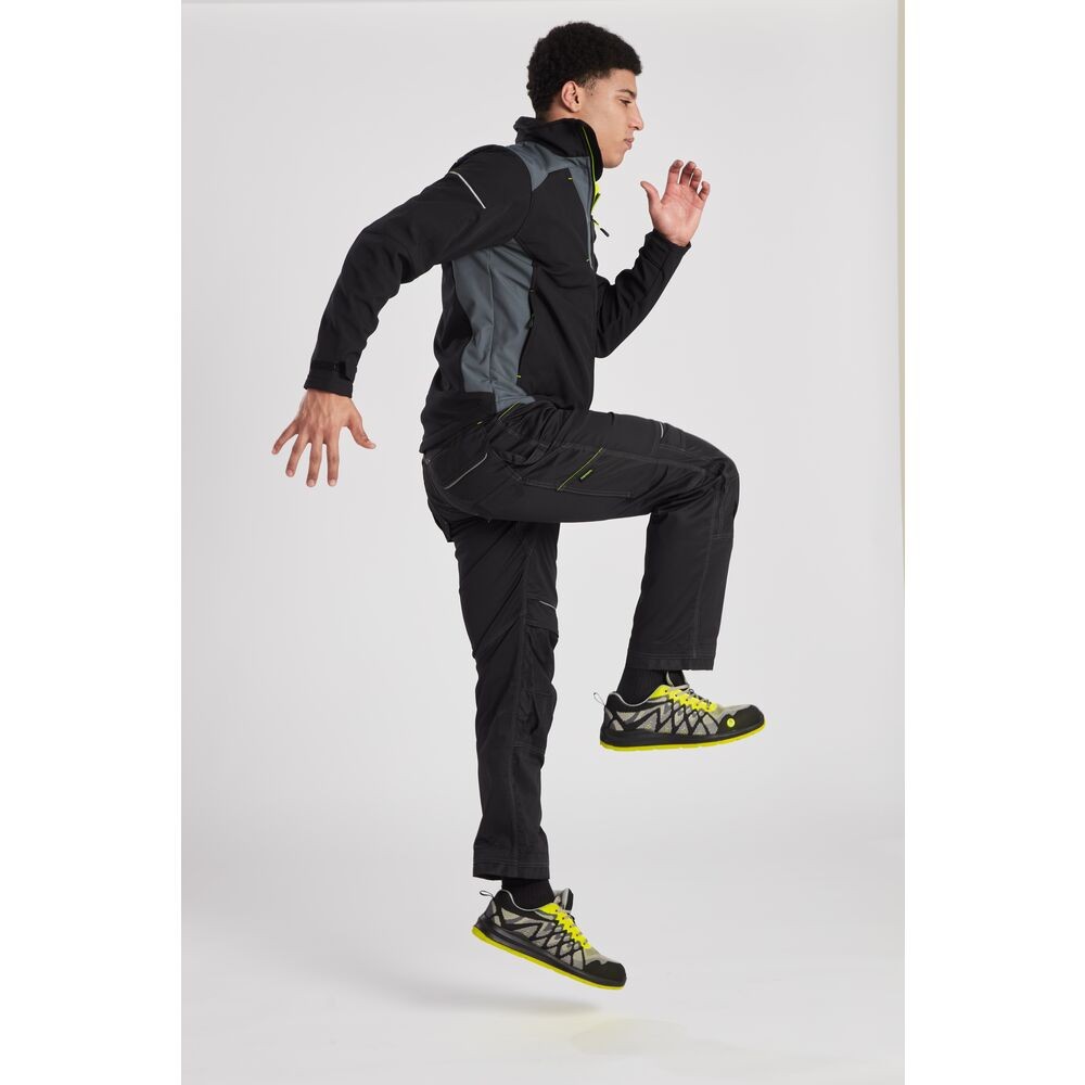 A black softshell jacket designed for use on construction sites and in industrial work environments.,