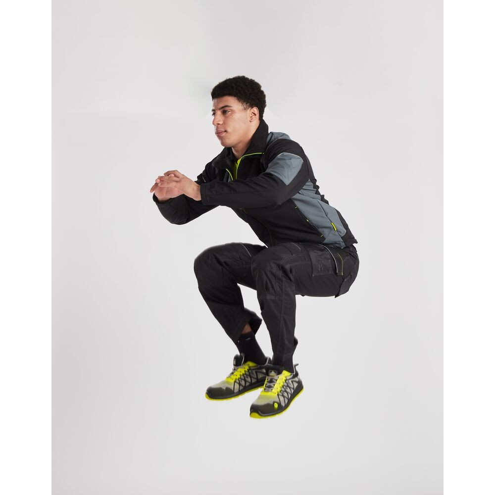 A black softshell jacket designed for use on construction sites and in industrial work environments.,