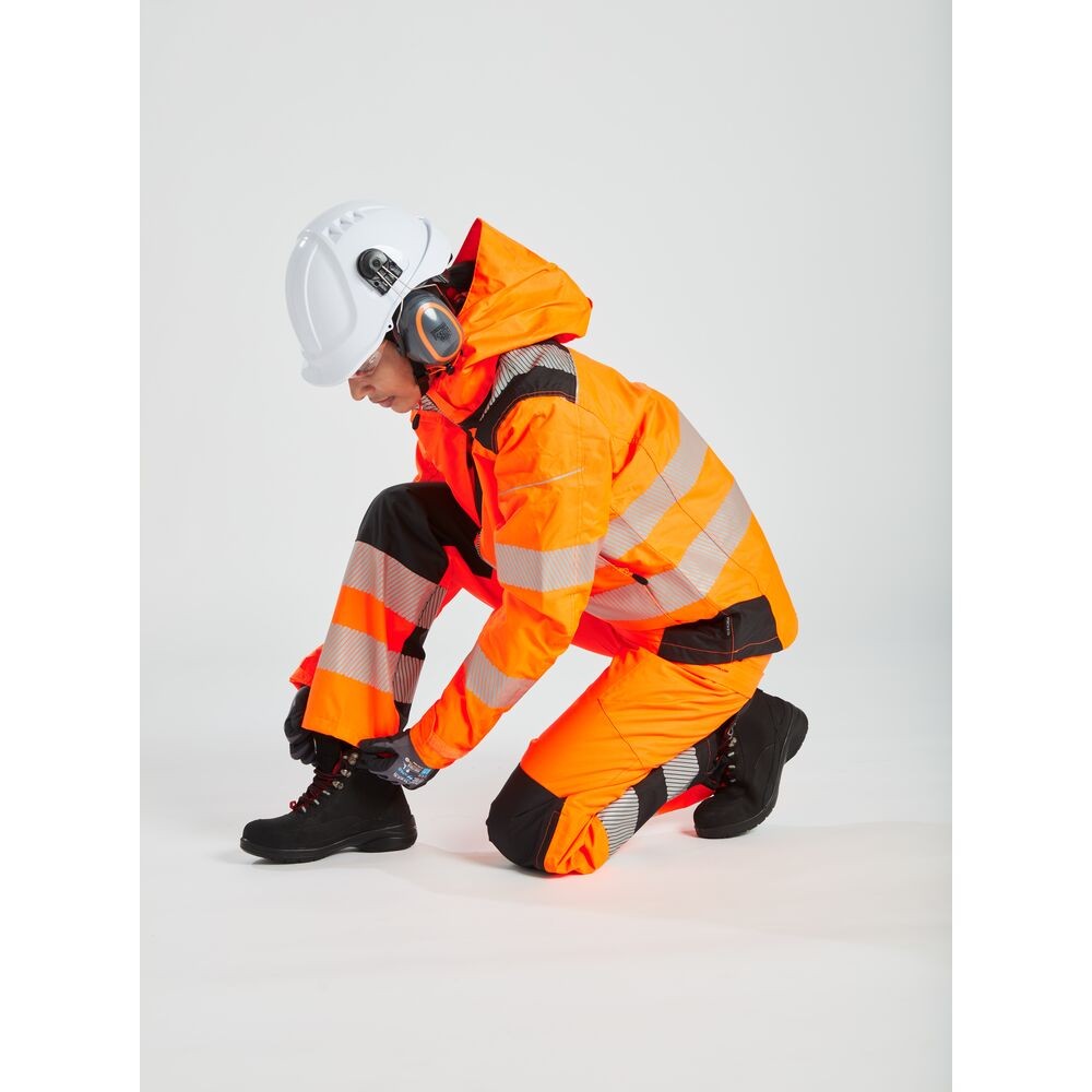 A women's high-visibility orange jacket featuring retroreflective tape panels, suitable for a wide range of outdoor and site work applications.