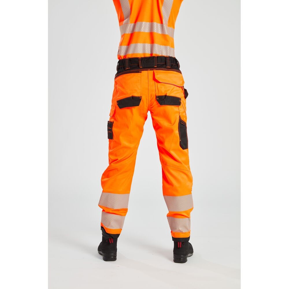 A pair of women's high-visibility orange trousers featuring retroreflective tape panels, stretch panels for ease of movement, suitable for a wide range of outdoor and site work applications.
