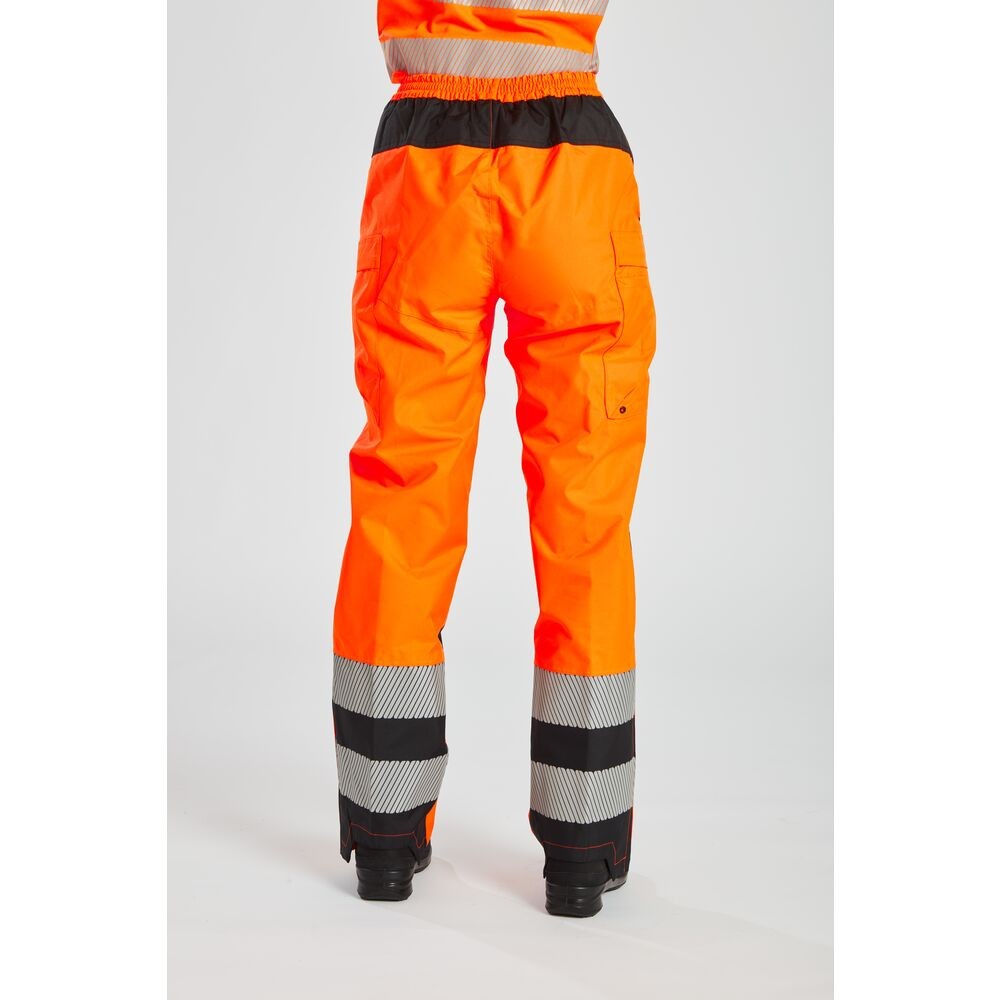 A pair of women's high-visibility orange trousers featuring retroreflective tape panels, suitable for a wide range of outdoor and site work applications.