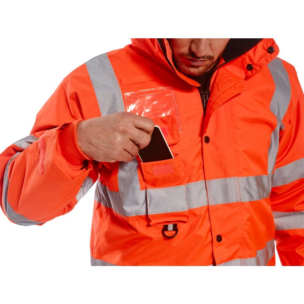 A high-visibility orange waterproof jacket featuring retroreflective tape panels, a breathable membrane, suitable for a wide range of outdoor and site work applications.