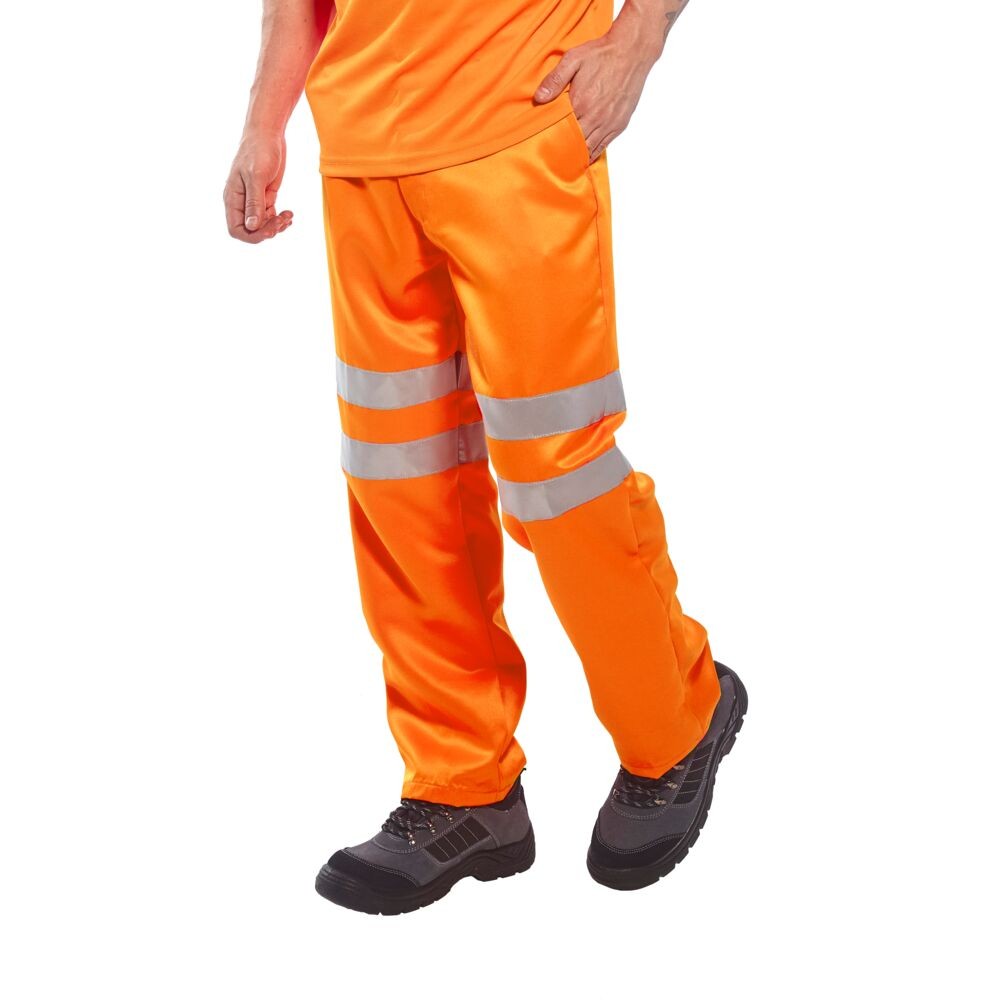 A pair of high-visibility orange trousers featuring retroreflective tape panels, suitable for a wide range of outdoor and site work applications.