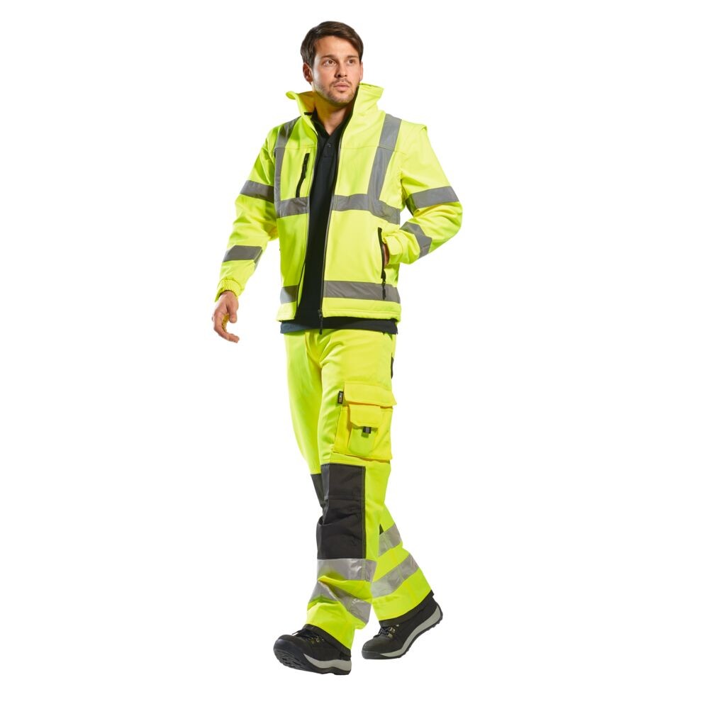 A high-visibility yellow softshell jacket featuring retroreflective tape panels, suitable for a wide range of outdoor and site work applications.
