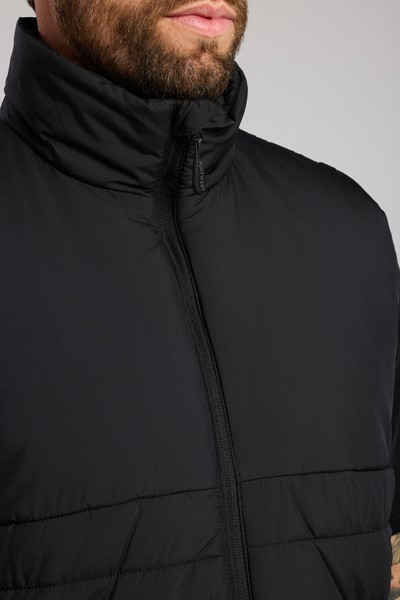 A black safety vest featuring a warm thermal lining, suitable for a wide range of outdoor and site work applications.