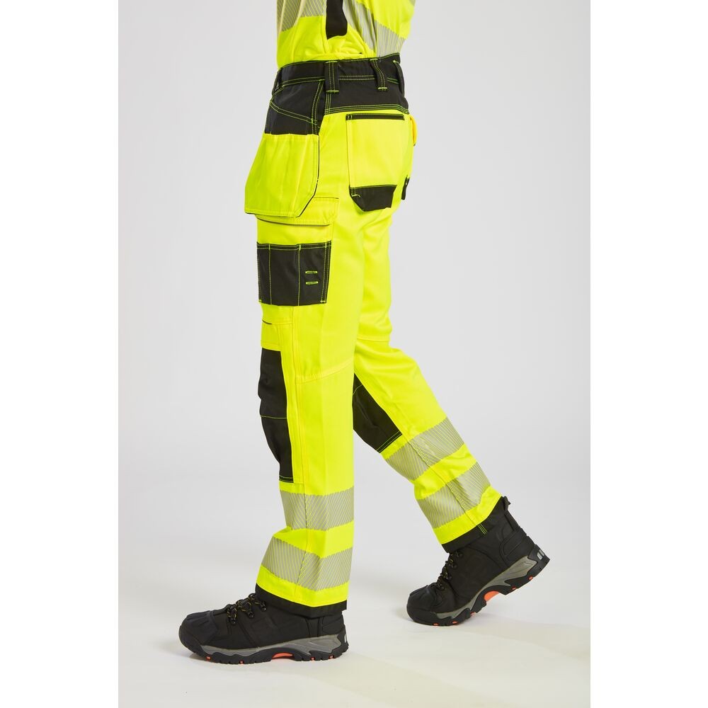 A pair of high-visibility yellow trousers featuring retroreflective tape panels, functional pockets, suitable for a wide range of outdoor and site work applications.