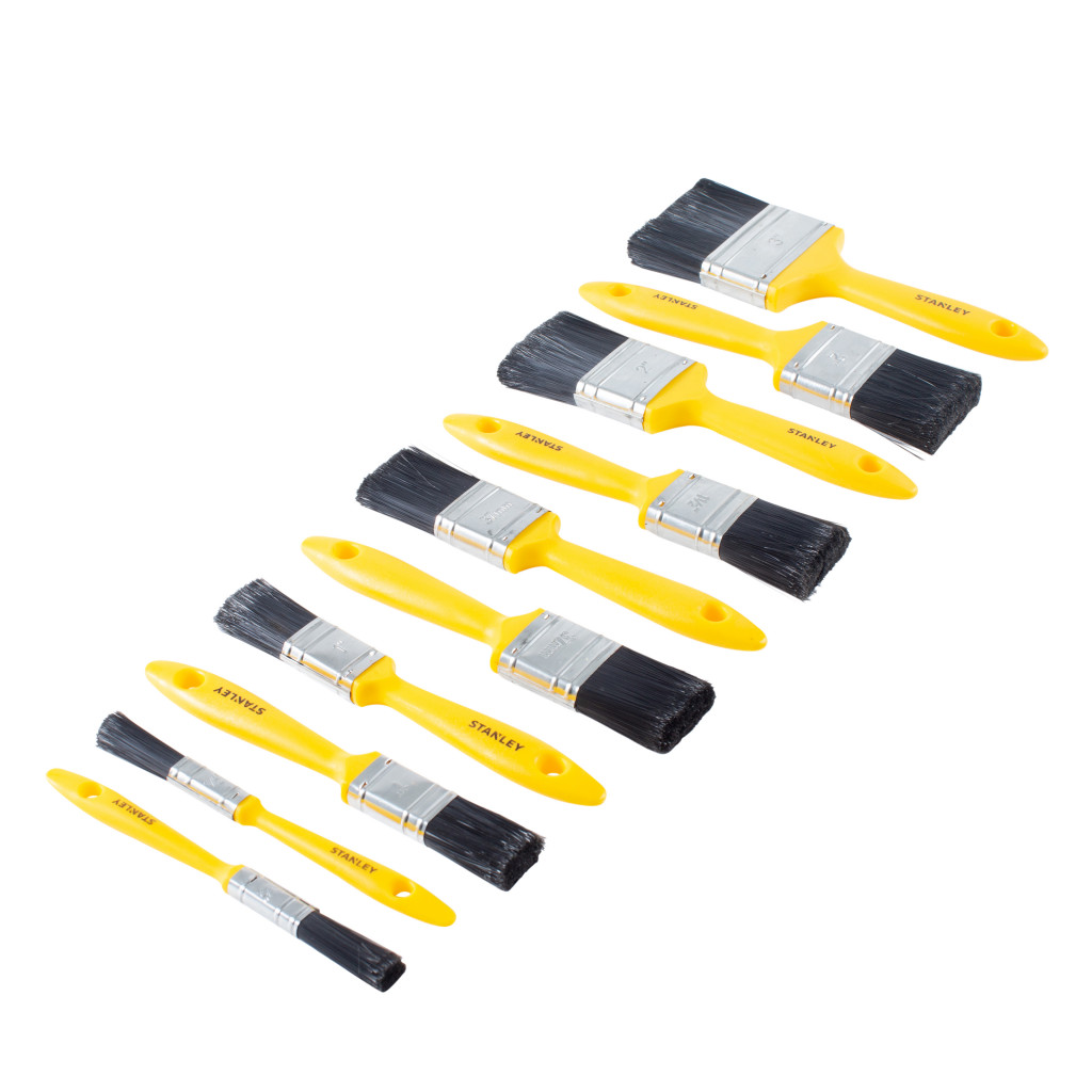 Nine yellow-handled paintbrushes of varying sizes are arranged in a diagonal line on a white background. Each brush has black bristles and a metal ferrule.,