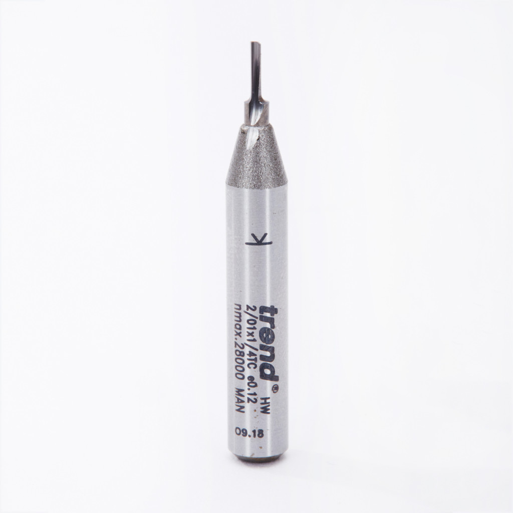 A close-up of a metal router bit with trend and technical specifications printed on its cylindrical body, standing upright on a white background.