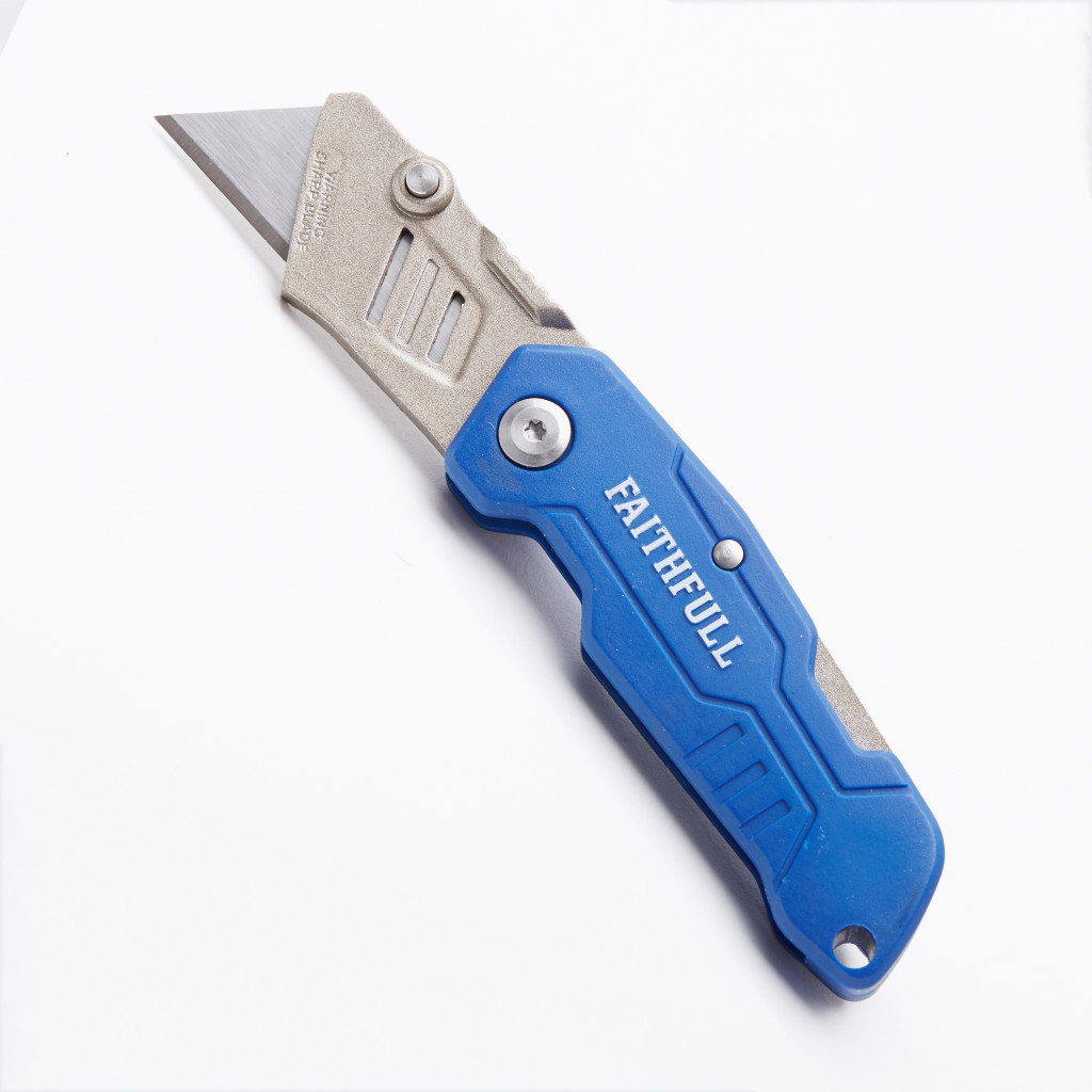 A blue and silver utility knife with the brand name FAITHFULL printed on the handle, lying on a white surface.