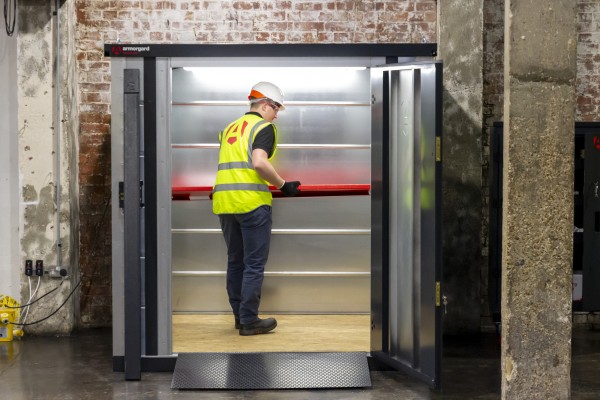 A steel metal shelving unit with adjustable shelf heights and a robust welded steel frame, for organised storage in workshops and site cabins.