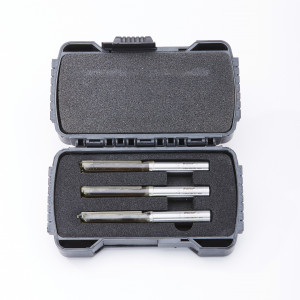 A black plastic case with foam padding holds three silver drill bits arranged in a row. The case is open and the drill bits are neatly secured in individual slots. The background is white.,